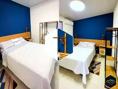 two beds in a room with blue walls at Casa Brisa Volcanica - Residencial Nueva San Miguel with AC in San Miguel