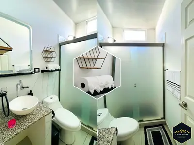 a white bathroom with two toilets and a sink at Casa Brisa Volcanica - Residencial Nueva San Miguel with AC in San Miguel