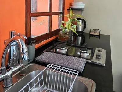 a kitchen counter with a sink and a window at Casa Juanita Juayua in Juayúa