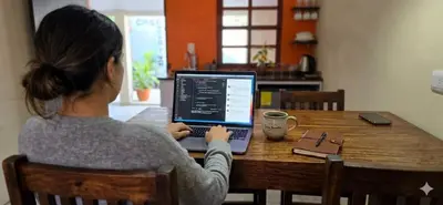a woman sitting at a table with a laptop computer at Casa Juanita Juayua in Juayúa