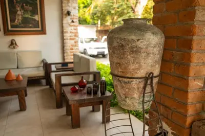 a large vase sitting on the side of a brick wall at Amalfi Surf Lodge in ChiltiupÃ¡n
