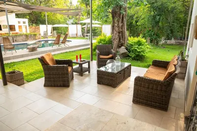 a patio with chairs and a table and a pool at Amalfi Surf Lodge in ChiltiupÃ¡n