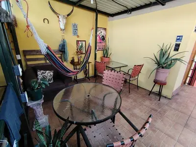 a room with a table and chairs and a couch at Rooms libertad in San Salvador