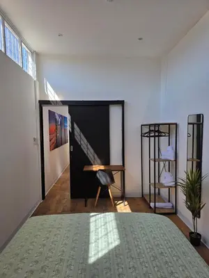 a room with a table and a chair and a desk at Apartamento nuevo a 90m del Magico con 2 parqueos incluidos in San Salvador