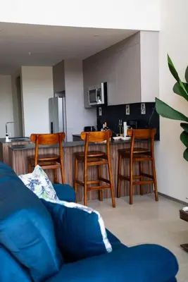 a living room with a couch and a kitchen at Oceanview Greco Loft in Playa San Blas