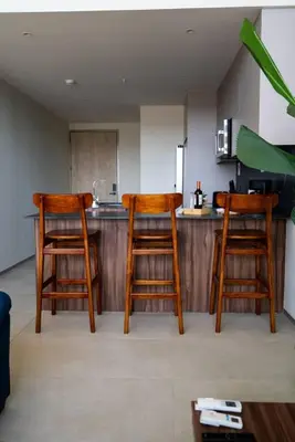 two wooden stools in a kitchen with a counter at Oceanview Greco Loft in Playa San Blas