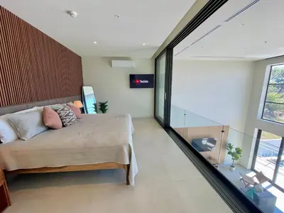 a bedroom with a bed and a large window at Oceanview Loft Mare in Playa San Blas