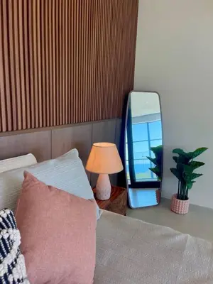 a bedroom with a bed with a mirror and a lamp at Oceanview Loft Mare in Playa San Blas