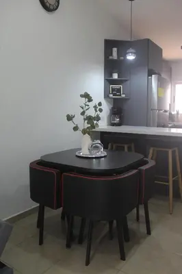 a black table with a plant on it in a kitchen at Casa maea loma alta in Sonzacate