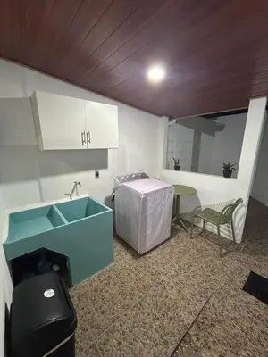 a kitchen with a sink and a table in a room at Casa maea loma alta in Sonzacate