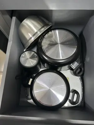 a drawer with a bunch of plates and pans at Casa maea loma alta in Sonzacate