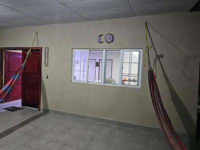 an empty room with a window and a door at Honey Beach House in La Esmeralda