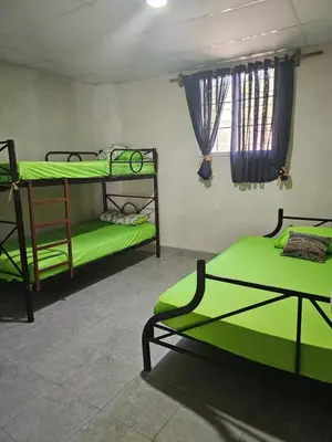 a room with two bunk beds and a window at Honey Beach House in La Esmeralda