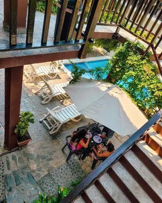an overhead view of people sitting in chairs with an umbrella at Papaya Lodge in La Libertad