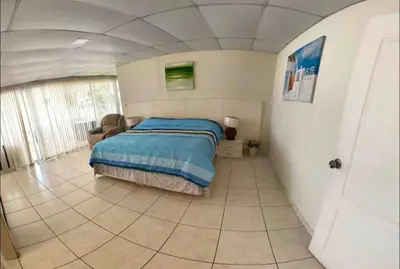 a bedroom with a bed and a tiled floor at House in Costa del Sol with beach access 5 bedrooms in Marcelino
