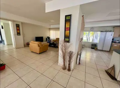 a living room with a couch and a surfboard at House in Costa del Sol with beach access 5 bedrooms in Marcelino