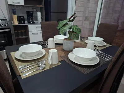 a table with white plates and silverware on it at Casa Chaparrastique in San Miguel