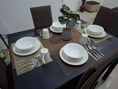 a table with white plates and silverware on it at Casa Chaparrastique in San Miguel