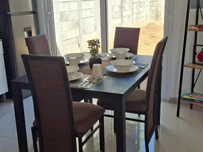 a dining room table and chairs with a blue table and chairsuggest at Casa Chaparrastique in San Miguel