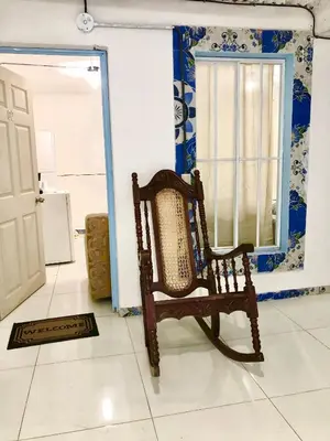 a rocking chair in a room with a window at Hostal Los planes de Renderos