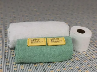 two towels and a roll of toilet paper on a table at Hostal Los planes de Renderos