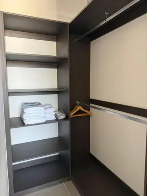 a walk in closet with black and white shelves at Apartamento en la mejor zona - San Benito ARTHAUS in San Salvador