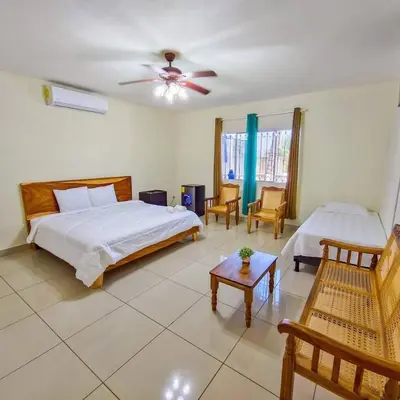 a bedroom with a bed and a ceiling fan at Hotel y restaurante el faro resort in San Salvador