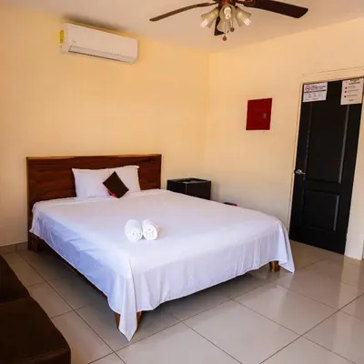 a bedroom with a bed with two white pillows on it at Hotel y restaurante el faro resort in San Salvador