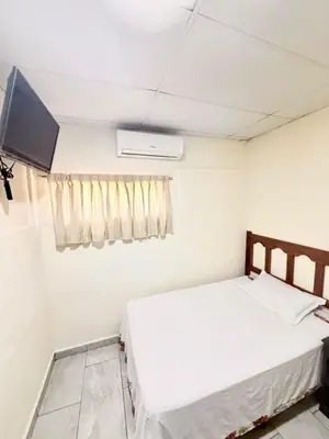 a small bedroom with a bed and a tv at Hotel Pablo Tesák in San Vicente