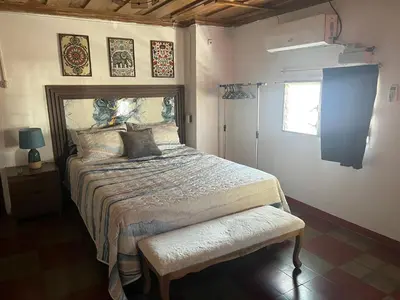 a bedroom with a large bed and a window at Club 27 - Hostal, Cafe & Spa in Santa Ana