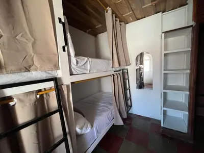 a room with two bunk beds in a room at Club 27 - Hostal, Cafe & Spa in Santa Ana