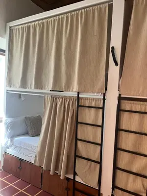 a bunk bed in a room with a window at Club 27 - Hostal, Cafe & Spa in Santa Ana