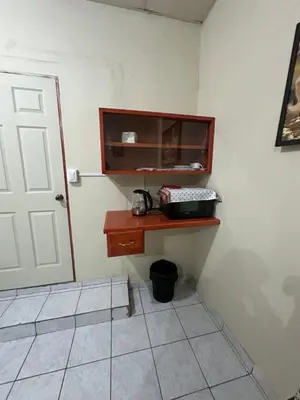 a corner of a room with a door and a table at Hostal las brisas in El Rosario