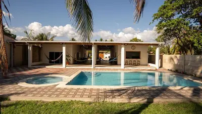 a house with a swimming pool in the yard at Ranch Pacific Dreams Home in Playa Cangrejeras