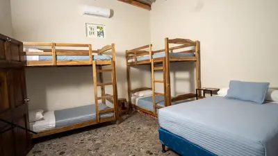 a room with two bunk beds and a bed at Ranch Pacific Dreams Home in Playa Cangrejeras
