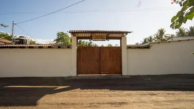 a wooden door of a house with a roof at Ranch Pacific Dreams Home in Playa Cangrejeras