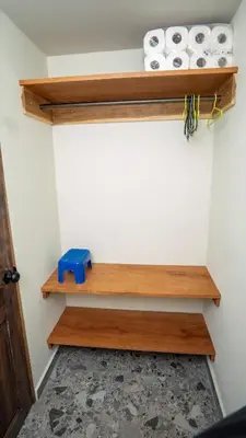 a room with wooden shelves and rolls of toilet paper at Ranch Pacific Dreams Home in Playa Cangrejeras