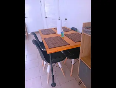 a wooden table with four black chairs around it at Casa de Milo in Ahuachapán