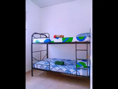 a room with two bunk beds in a room at Casa de Milo in Ahuachapán