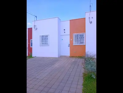 a building with white doors and a brick driveway at Casa de Milo in Ahuachapán