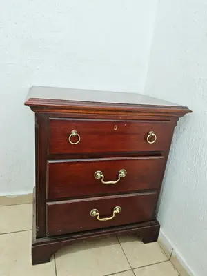 a wooden dresser sitting next to a wall at La casa de Alex in San Juan Opico