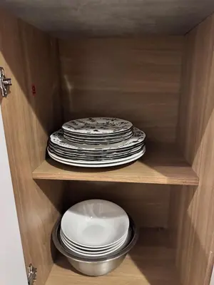 a stack of plates and dishes in a cabinet at La Santanita in Santa Ana