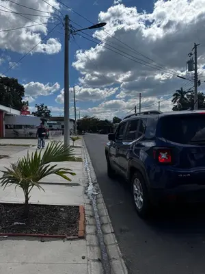 a blue suv parked on the side of a street at La Santanita in Santa Ana