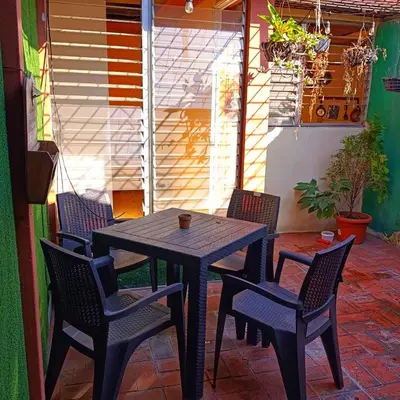 a black table and chairs on a patio at Casa de Mango in Antiguo Cuscatlán