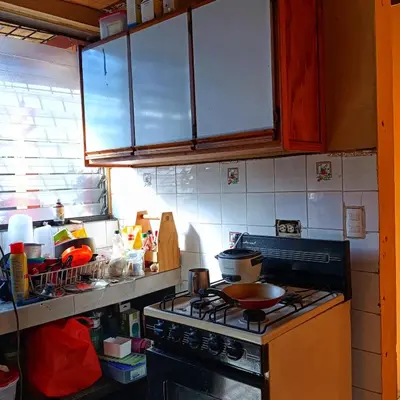 a kitchen with a stove with a pot on it at Casa de Mango in Antiguo Cuscatlán