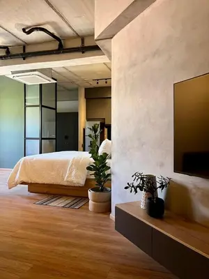a bedroom with a bed and a flat screen tv at Modern and Stylish Studio Near Parks El Espino District in San Salvador