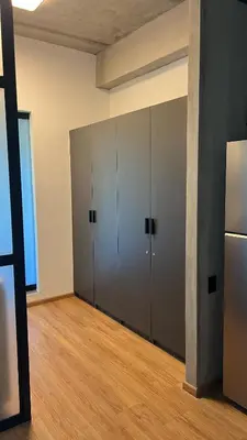 an empty room with three lockers and a refrigerator at Modern and Stylish Studio Near Parks El Espino District in San Salvador