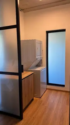 an empty kitchen with a refrigerator and a window at Modern and Stylish Studio Near Parks El Espino District in San Salvador