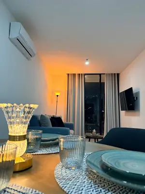 a living room with a table and a blue couch at Cozy apartment in San Benito in San Salvador