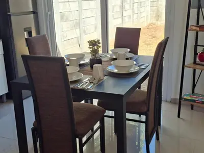 a dining room table with chairs and a blue table and chairsuggest at Nueva San Miguel - Casa Chaparrastique in San Miguel